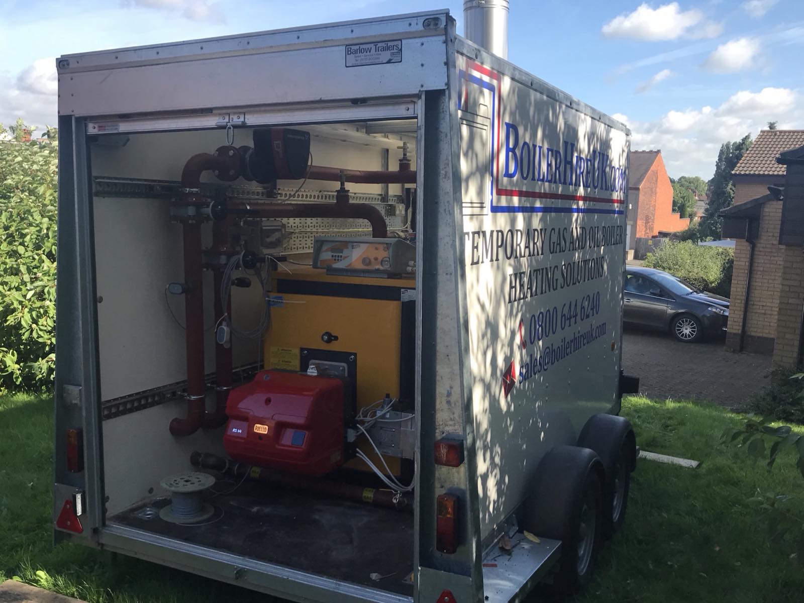A 300kW trailer mounted temporary boiler with its side open showing the burner and pipework