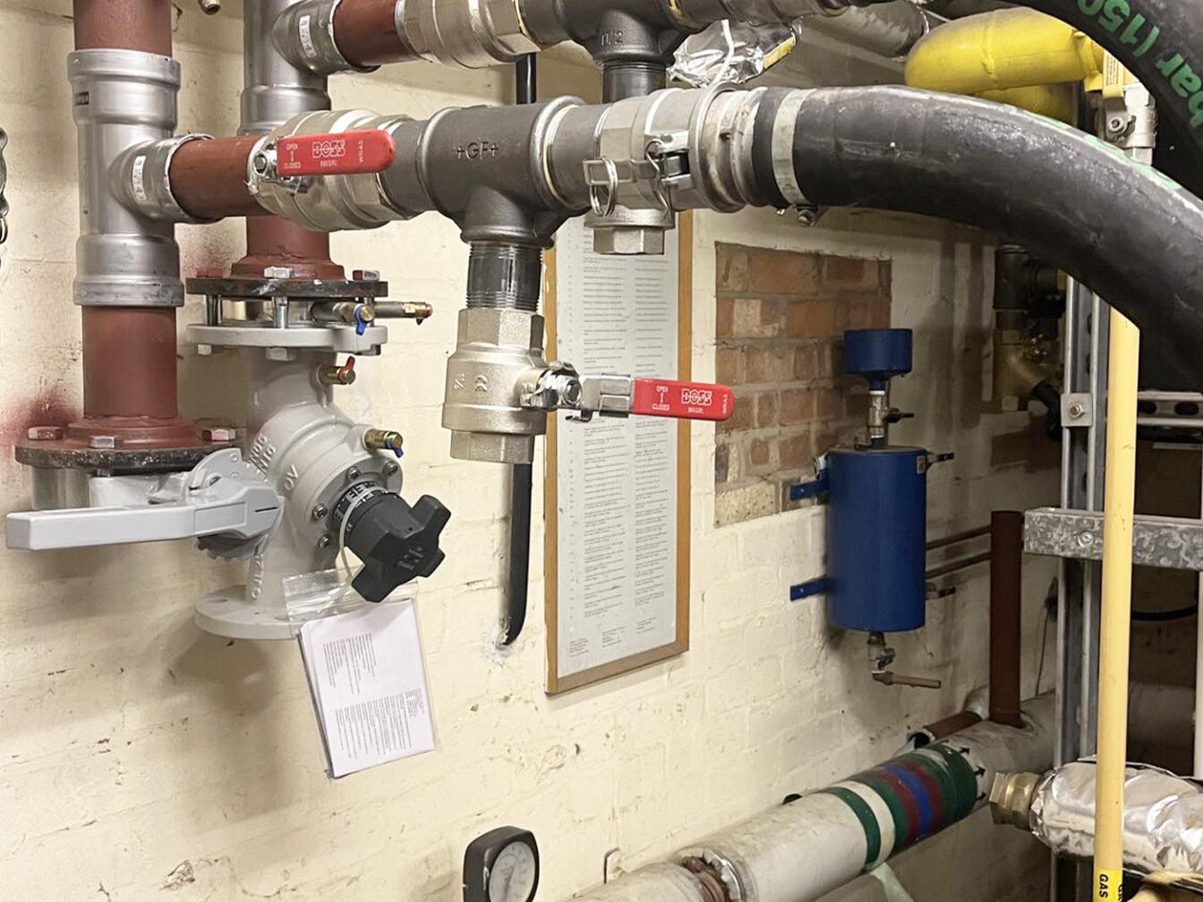 Temporary boiler hoses connected into a building's pipework through a header