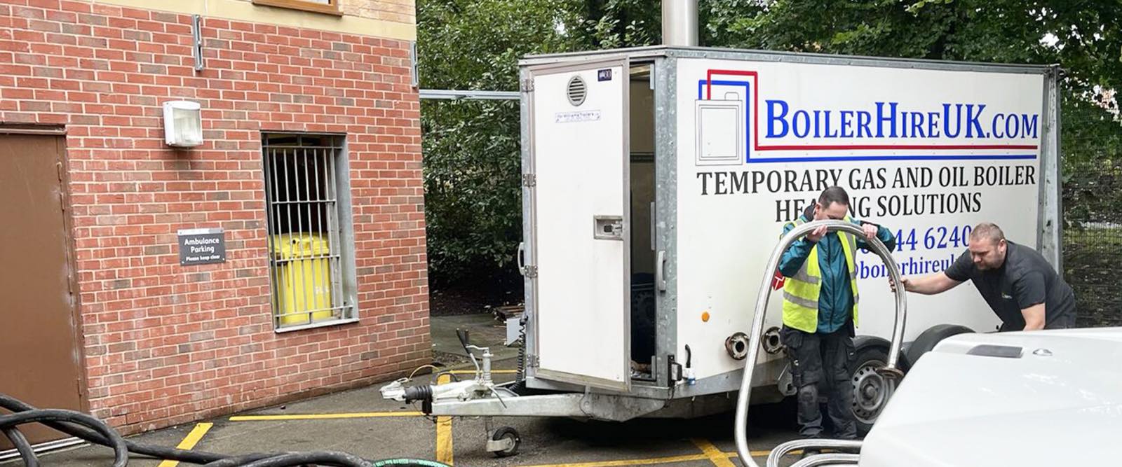 Boiler Hire UK engineers connecting a temporary boiler outside a building